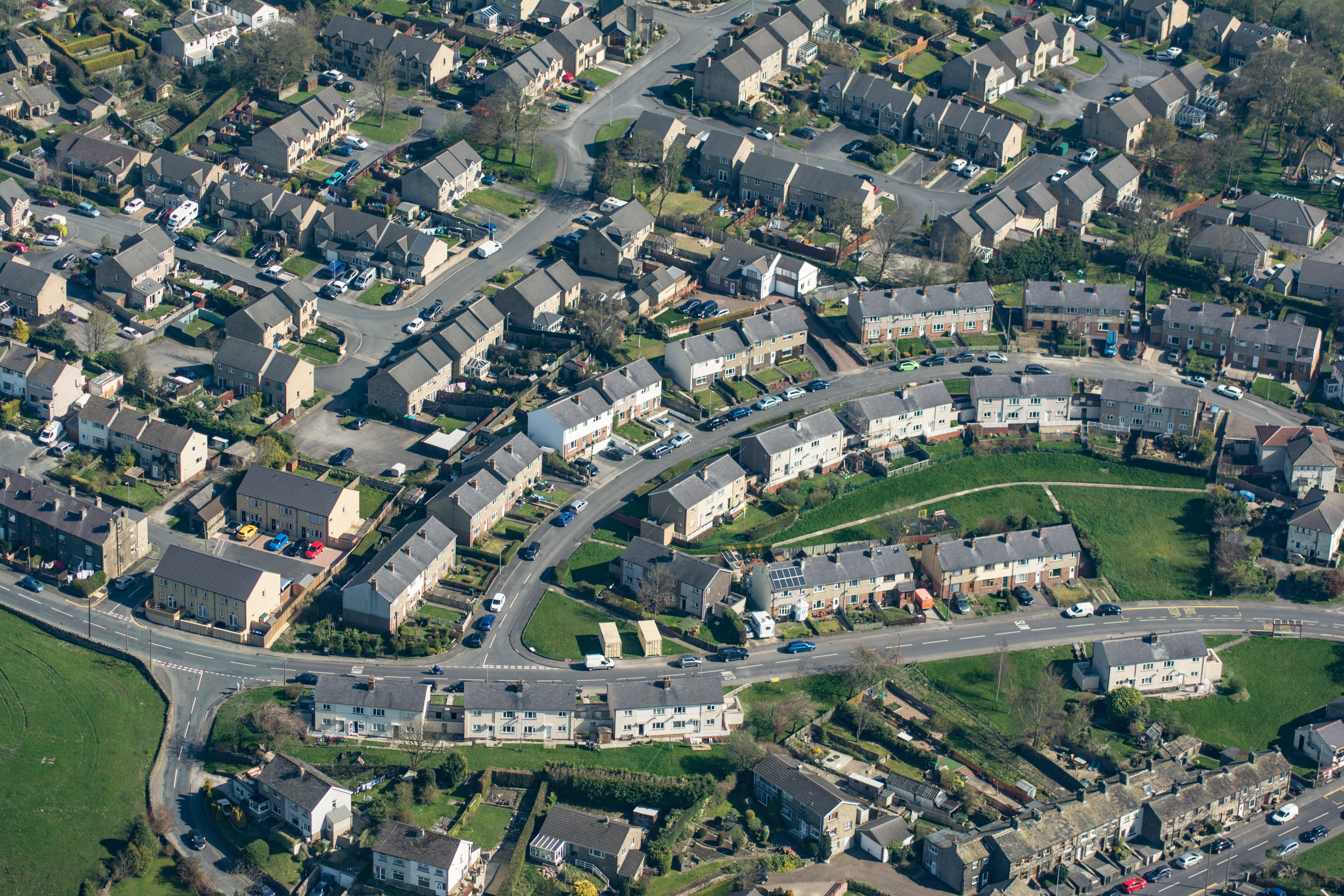 arial view of houses with green grass and residential streets